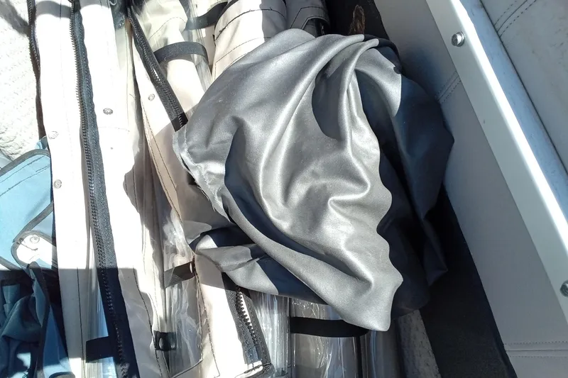 Slide: The Image of Storage compartment with fabric and zippers on a 2003 Godfrey SANPAN 2500 boat. - 25