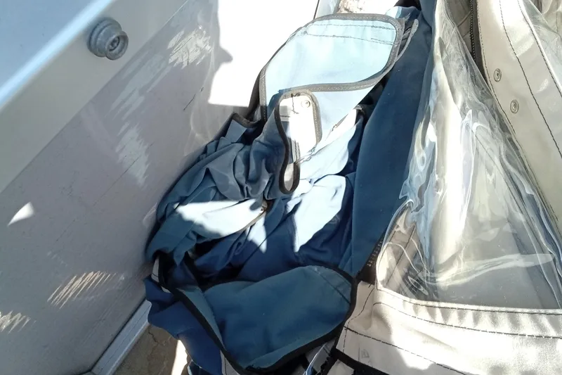 Slide: The Image of Blue fabric and clear plastic on a 2003 Godfrey SANPAN 2500 boat interior. - 26