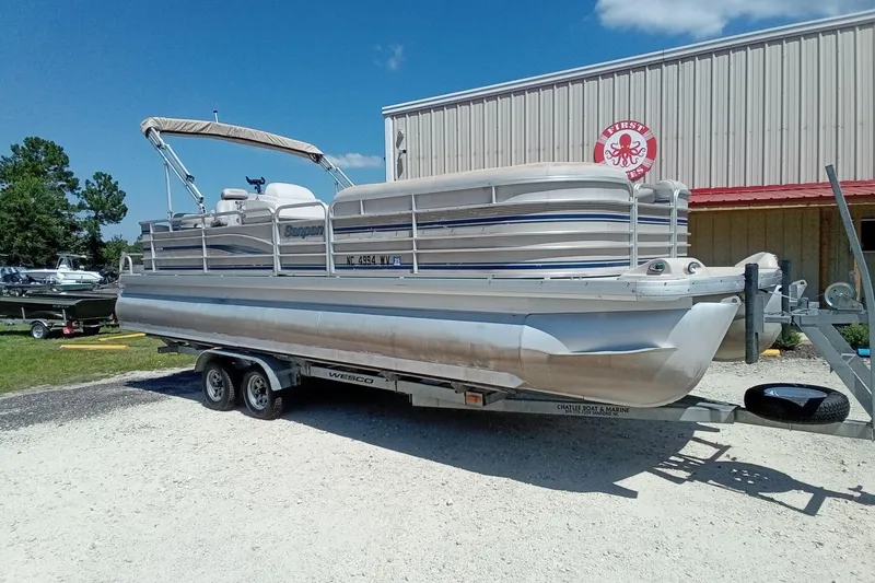 Slide: The Image of 2003 Godfrey SANPAN 2500 pontoon boat on trailer, parked outdoors. - 3