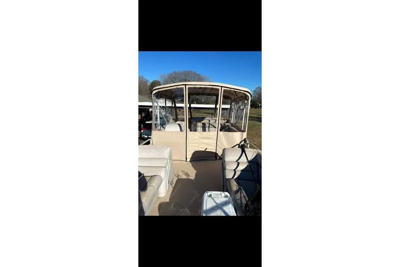 Slide: The Image of 2003 Godfrey SANPAN 2500 pontoon boat with beige canopy and seating. - 30