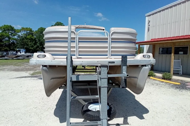 Slide: The Image of 2003 Godfrey SANPAN 2500 pontoon boat on trailer, parked outdoors near a building. - 5