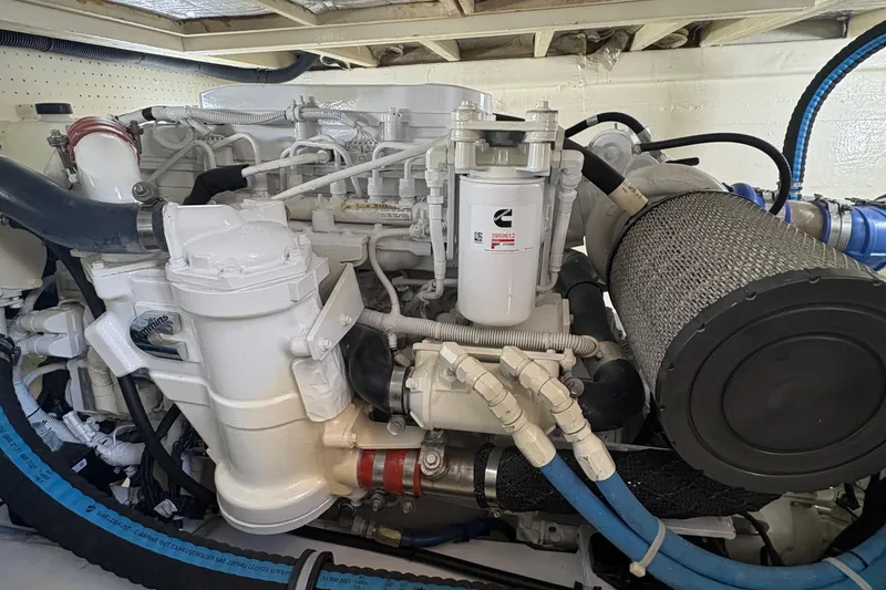 Slide: The Image of 1988 Egg Harbor 37 Convertible yacht with wooden accents and ladder, docked at marina. - 12