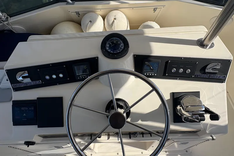 Slide: The Image of 1988 Egg Harbor 37 Convertible yacht interior with marina view, showcasing wood accents and cozy cabin. - 13