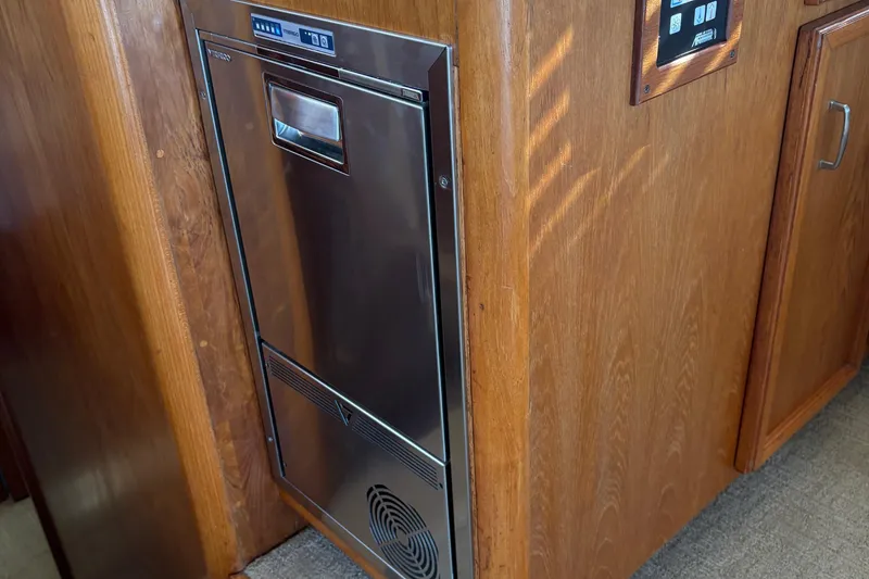 Slide: The Image of Interior of 1988 Egg Harbor 37 Convertible yacht with wood cabinetry and seating area. - 17