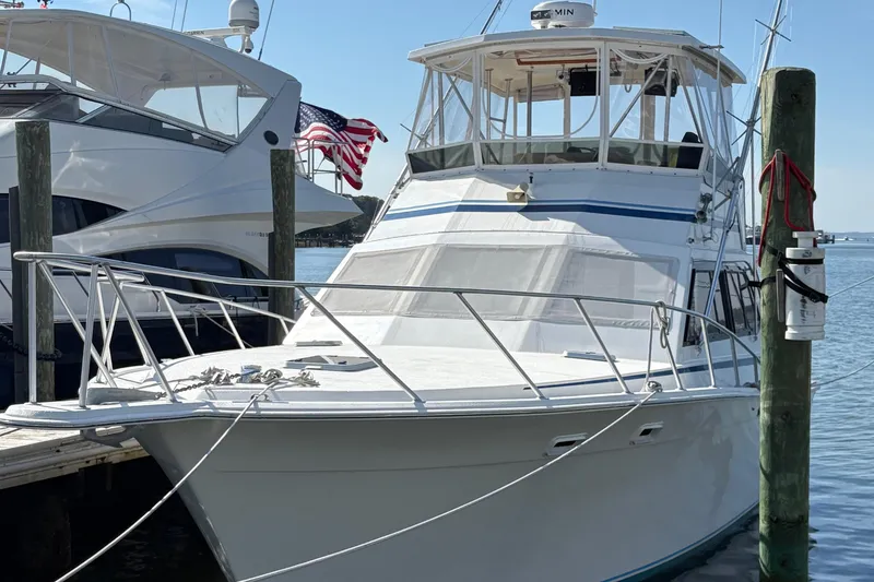 Slide: The Image of 1988 Egg Harbor 37 Convertible yacht docked at a marina, surrounded by other boats. - 35