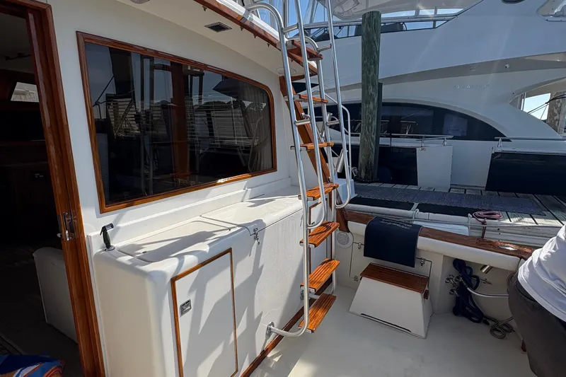 Slide: The Image of 1988 Egg Harbor 37 Convertible boat deck, docked with polished wood accents. - 38