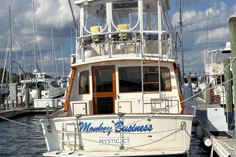 Slide: The Image of 1988 Egg Harbor 37 Convertible yacht docked, featuring sleek design and spacious deck. - 4