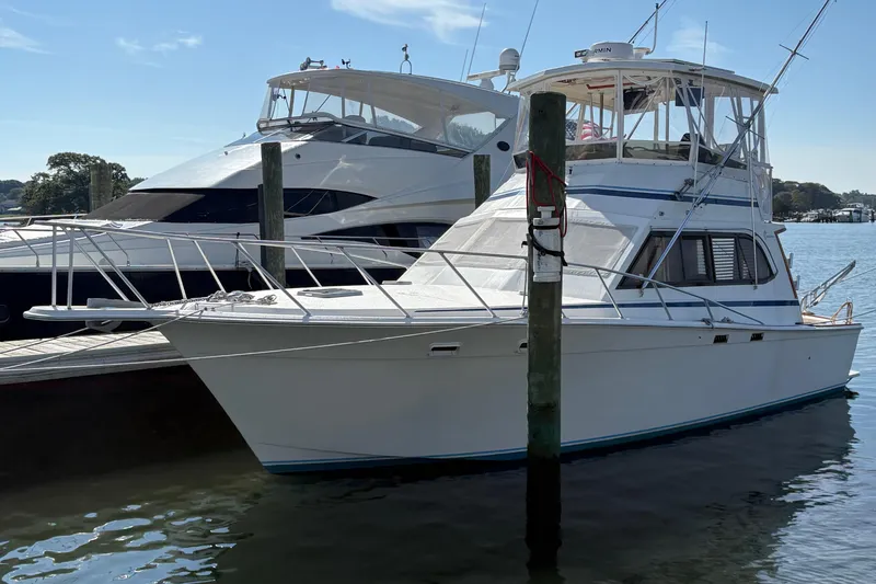 Slide: The Image of Engine compartment of 1988 Egg Harbor 37 Convertible boat, showing mechanical components and wiring. - 43