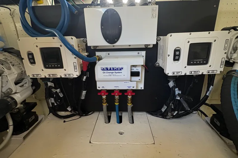 Slide: The Image of Engine room of 1988 Egg Harbor 37 Convertible boat, showcasing hoses and components. - 46