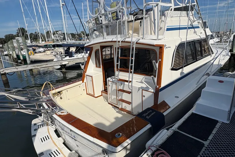 Slide: The Image of Engine compartment of 1988 Egg Harbor 37 Convertible boat, showing mechanical components and wiring. - 51
