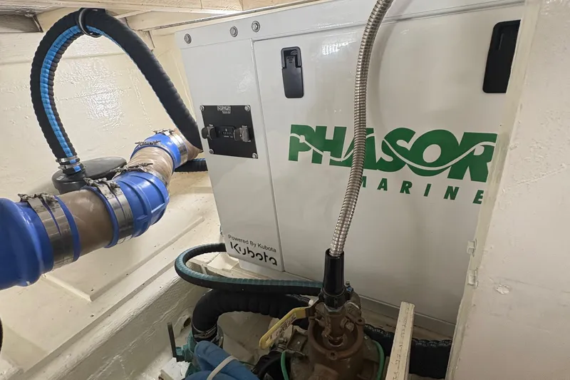 Slide: The Image of Engine room of 1988 Egg Harbor 37 Convertible with visible exhaust system and components. - 57