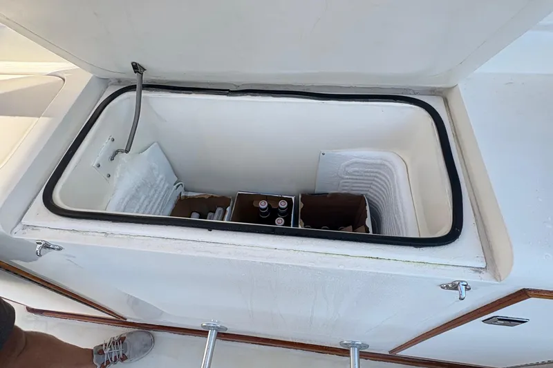 Slide: The Image of 1988 Egg Harbor 37 Convertible yacht docked at a marina, featuring a spacious deck. - 7