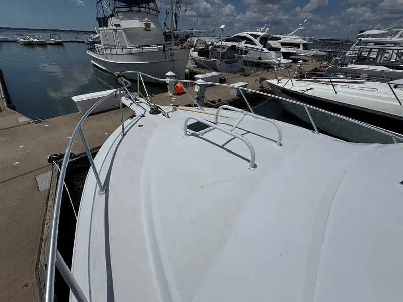 Slide: The Image of 1998 Ocean Yachts 40 Super Sport docked at marina under clear skies. - 10