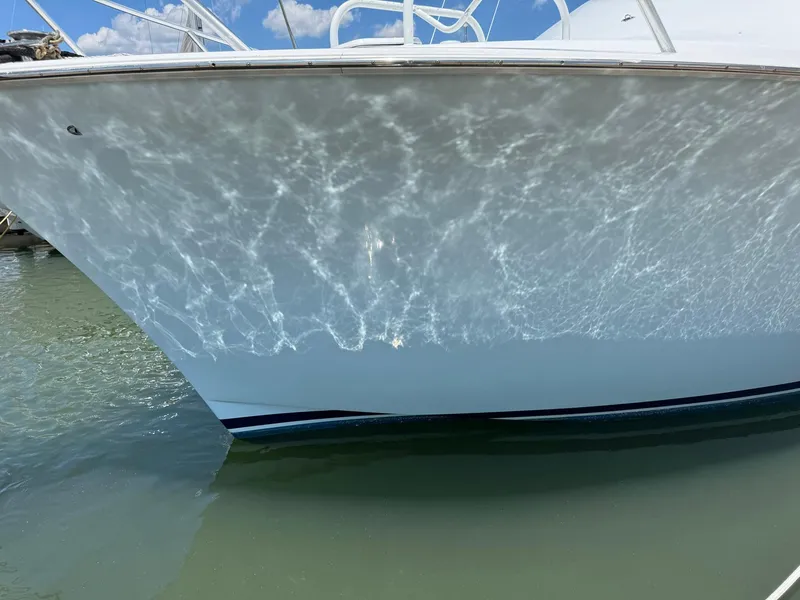 Slide: The Image of 1998 Ocean Yachts 40 Super Sport reflecting sunlight on calm water. - 13