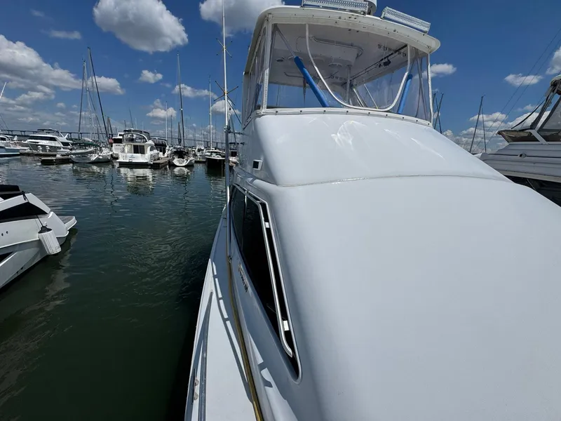 Slide: The Image of 1998 Ocean Yachts 40 Super Sport docked at marina under blue sky. - 14