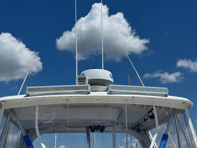 Slide: The Image of 1998 Ocean Yachts 40 Super Sport boat under a clear blue sky with clouds. - 15
