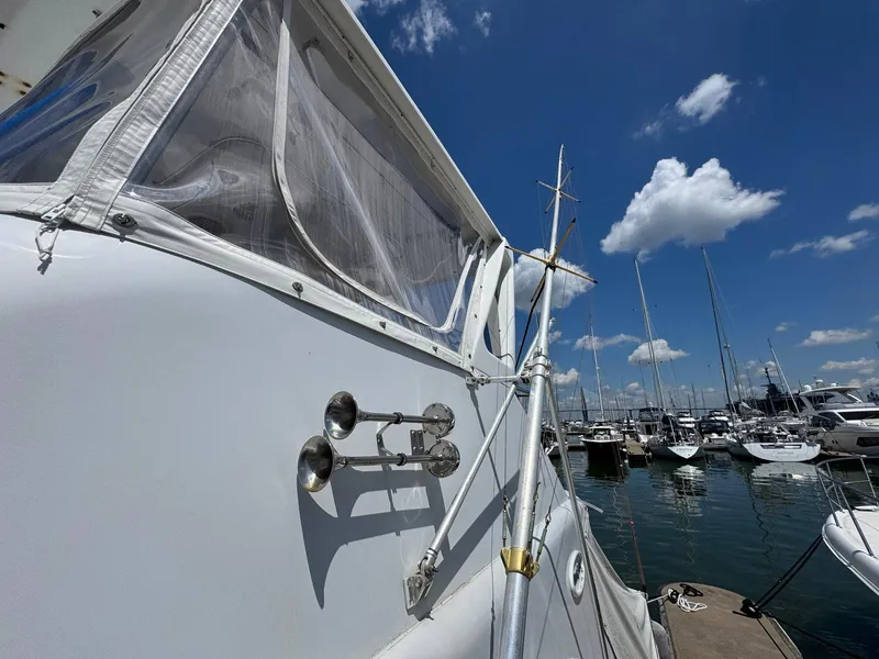 Slide: The Image of 1998 Ocean Yachts 40 Super Sport docked at marina under clear blue sky. - 16