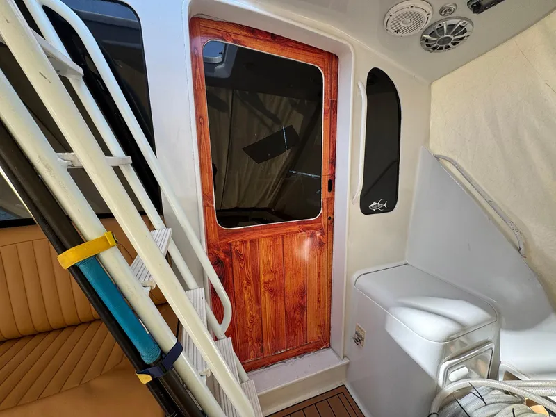 Slide: The Image of 1998 Ocean Yachts 40 Super Sport interior with wooden door and seating area. - 19