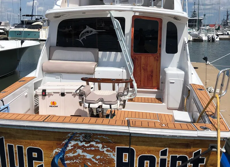 Slide: The Image of 1998 Ocean Yachts 40 Super Sport docked, featuring a spacious deck and fishing chair. - 3