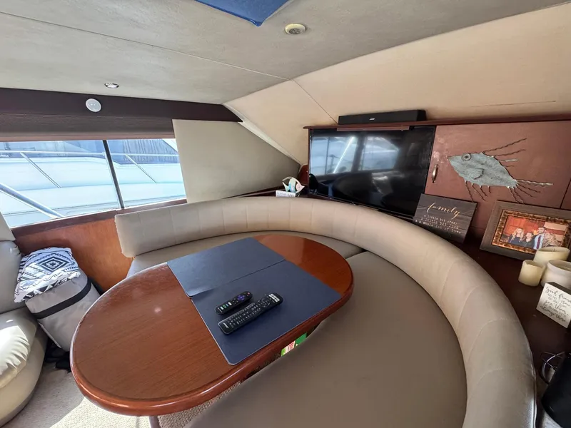 Slide: The Image of Interior of 1998 Ocean Yachts 40 Super Sport with curved seating and table. - 31