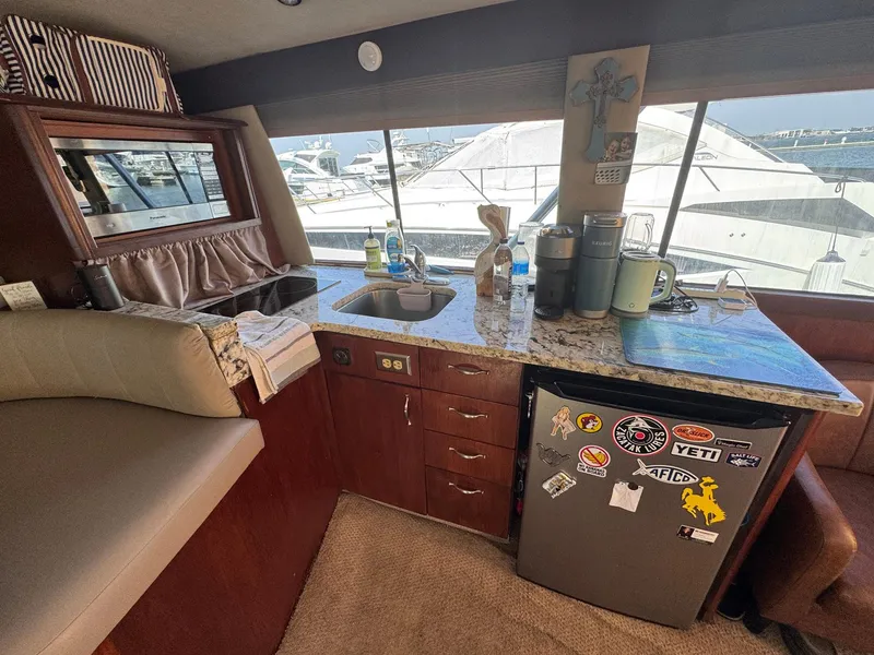 Slide: The Image of Interior of 1998 Ocean Yachts 40 Super Sport with kitchenette and marina view. - 34
