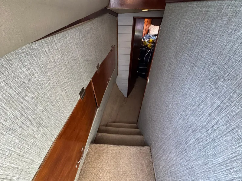 Slide: The Image of Stairway inside 1998 Ocean Yachts 40 Super Sport with carpet and wood paneling. - 36