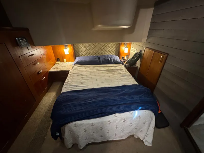 Slide: The Image of Cozy bedroom in 1998 Ocean Yachts 40 Super Sport with wood cabinetry and ambient lighting. - 37
