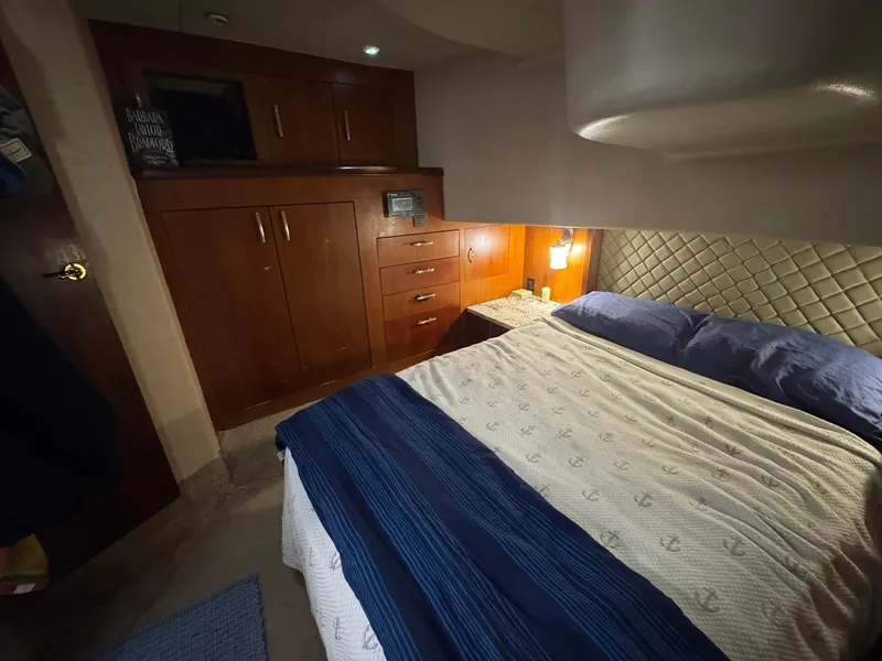 Slide: The Image of Luxurious cabin interior of a 1998 Ocean Yachts 40 Super Sport with cozy bedding. - 38