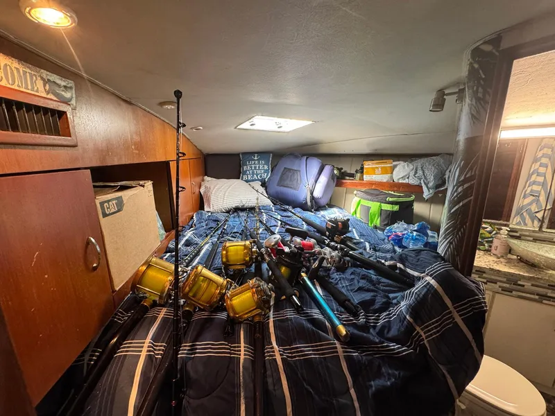 Slide: The Image of Cozy cabin interior of 1998 Ocean Yachts 40 Super Sport with fishing gear on bed. - 39