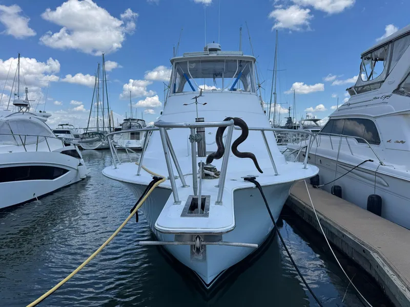 Slide: The Image of 1998 Ocean Yachts 40 Super Sport docked at marina under blue sky. - 4