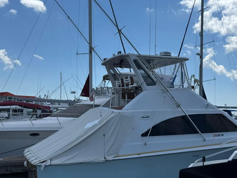 Slide: The Image of 1998 Ocean Yachts 40 Super Sport docked at marina under clear blue sky. - 5