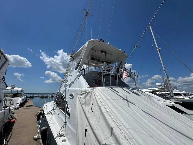 Slide: The Image of 1998 Ocean Yachts 40 Super Sport docked under a clear blue sky. - 9