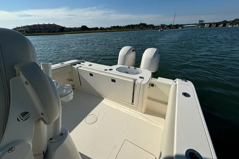 Slide: The Image of 2020 Cobia 280 Center Console boat on water, featuring dual engines and spacious deck. - 19