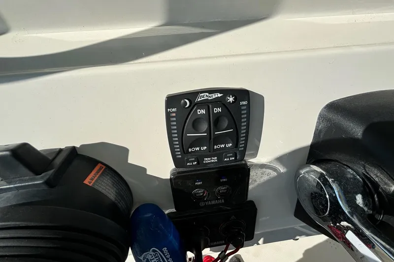 Slide: The Image of Control panel of a 2020 Cobia 280 Center Console boat with trim tab controls. - 22
