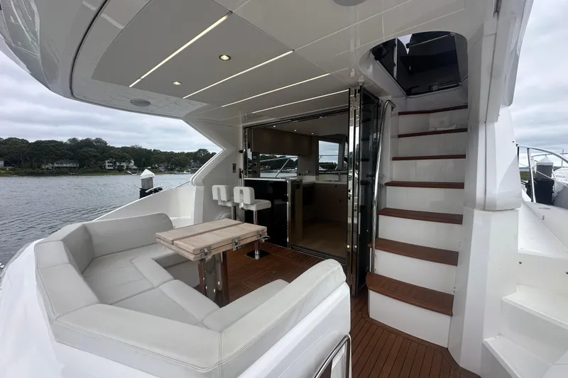 Slide: The Image of Luxurious 2018 Sunseeker Manhattan 52 yacht interior with seating, table, and stairs. - 11