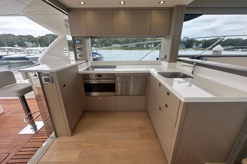 Slide: The Image of Luxurious 2018 Sunseeker Manhattan 52 yacht kitchen with modern appliances and scenic marina view. - 19