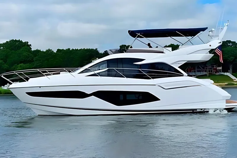 Slide: The Image of 2018 Sunseeker Manhattan 52 yacht on calm water, featuring sleek design and modern architecture. - 2