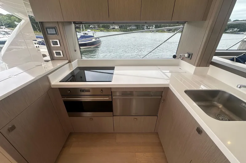Slide: The Image of Modern kitchen interior of 2018 Sunseeker Manhattan 52 yacht with sleek appliances and waterfront view. - 20