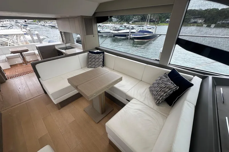 Slide: The Image of Luxurious interior of 2018 Sunseeker Manhattan 52 yacht with elegant seating and scenic marina view. - 27