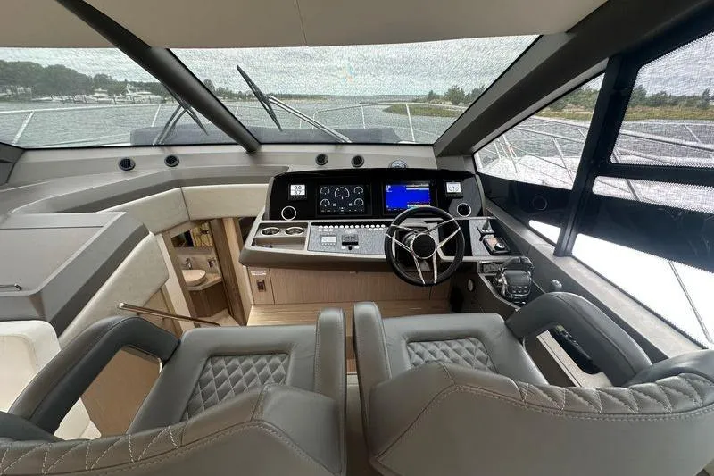 Slide: The Image of Interior cockpit of 2018 Sunseeker Manhattan 52 yacht with modern controls and seating. - 35