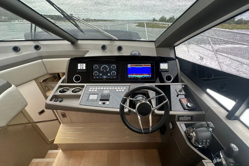 Slide: The Image of 2018 Sunseeker Manhattan 52 yacht helm with advanced navigation controls and sleek design. - 36