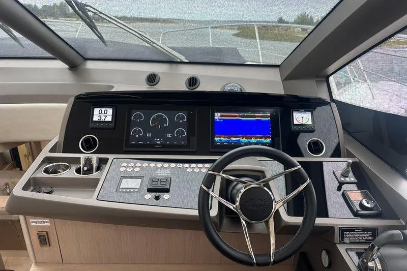 Slide: The Image of Helm of 2018 Sunseeker Manhattan 52 yacht with modern navigation controls. - 37