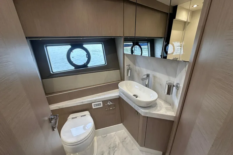 Slide: The Image of Luxurious bathroom in 2018 Sunseeker Manhattan 52 yacht with modern fixtures and porthole window. - 48