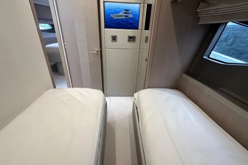 Slide: The Image of Interior of 2018 Sunseeker Manhattan 52 yacht with twin beds and window view. - 52