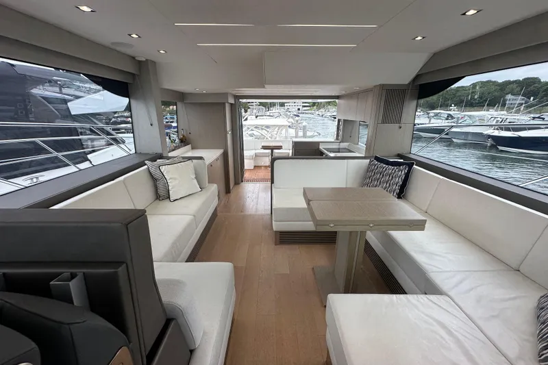 Slide: The Image of Luxurious interior of 2018 Sunseeker Manhattan 52 yacht with elegant seating and scenic marina view. - 65