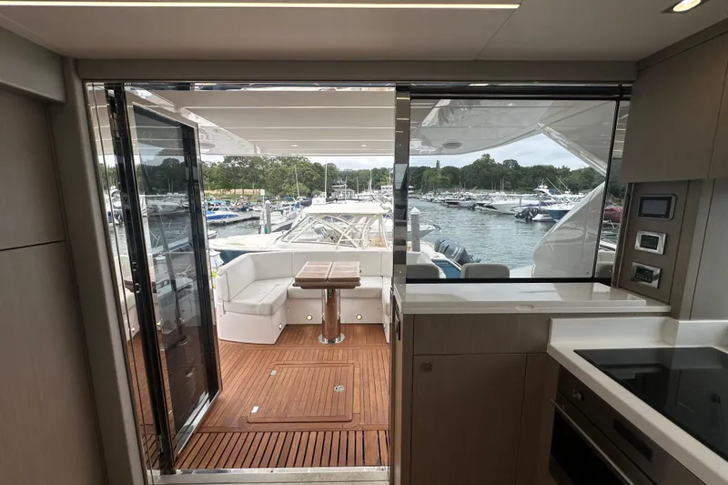 Slide: The Image of Interior view of 2018 Sunseeker Manhattan 52 yacht, featuring modern kitchen and outdoor seating area. - 67