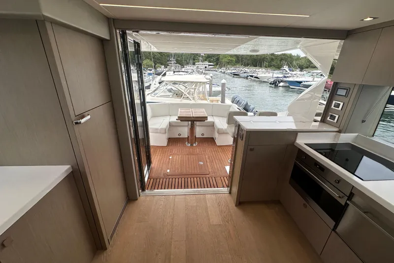 Slide: The Image of Interior view of 2018 Sunseeker Manhattan 52 yacht, featuring modern kitchen and outdoor seating area. - 68