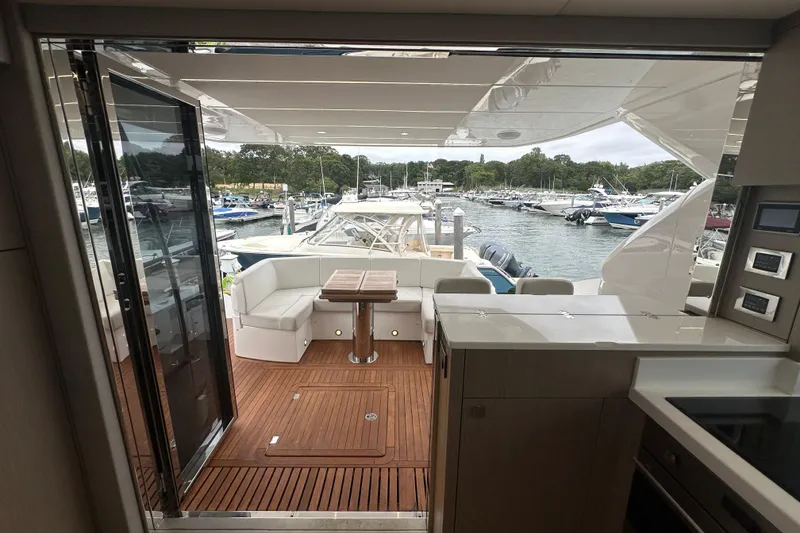Slide: The Image of Luxurious 2018 Sunseeker Manhattan 52 yacht interior with elegant wood flooring and marina view. - 69