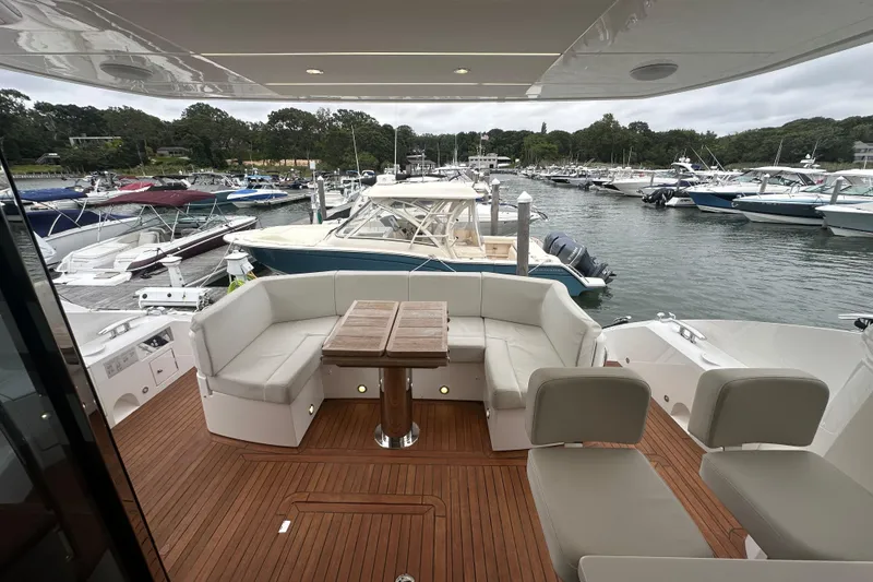 Slide: The Image of Luxurious 2018 Sunseeker Manhattan 52 yacht interior with elegant seating and marina view. - 70