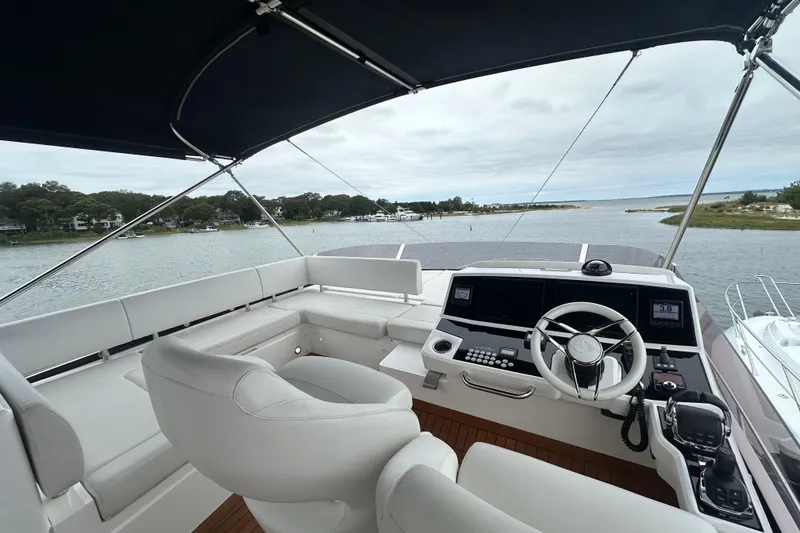 Slide: The Image of Flybridge view of 2018 Sunseeker Manhattan 52 yacht with modern helm and seating. - 76